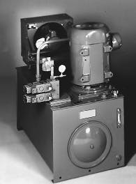 Figure 2. This modular power unit demonstrates a trend in hydraulic reservoir designs which includes mounting the electric motor vertically with the pump submerged in hydraulic fluid. This technique reduces leakage, noise, and floor space required. Figure 2. This modular power unit demonstrates a trend in hydraulic reservoir designs which includes mounting the electric motor vertically with the pump submerged in hydraulic fluid. This technique reduces leakage, noise, and floor space required.