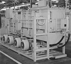 Figure 3. This industrial hydraulic power unit consists of five pump-motor assemblies supplied by an overhead hydraulic reservoir. The overhead mounting provides pressurized fluid to each pump's inlet, and mounting pump-motor assemblies offset from the reservoir provides access for lifting pump-motor assemblies from overhead. Figure 3. This industrial hydraulic power unit consists of five pump-motor assemblies supplied by an overhead hydraulic reservoir. The overhead mounting provides pressurized fluid to each pump's inlet, and mounting pump-motor assemblies offset from the reservoir provides access for lifting pump-motor assemblies from overhead.