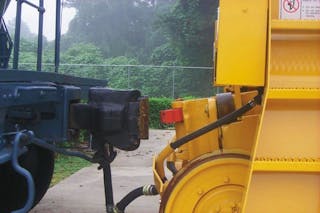 A weight-transfer coupler on a rail car mover approaches a standard coupler on car.