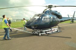 A single operator can maneuver the hydraulically powered Heliporter into position under a helicopter and easily raise it off the ground.