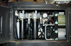 Open access panel reveals hydraulic components. White cylinder at extreme left is aerator. The tow black cylinders to its right are hydraulic filters, and the two large horizontal cylinders at far right are low-pressure accumulators., Photo by Alan Hitchcox.