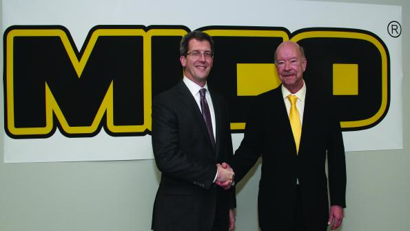 Jon Morrison left WABCO president Americas and Brent McGrath MICO president shake hands after closing the deal in which WABCO acquired MICO