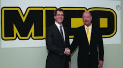 Jon Morrison (left), WABCO president, Americas, and Brent McGrath, MICO president, shake hands after closing the deal in which WABCO acquired MICO.
