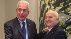 Rino Tarolli, left, of Dana Italy, and Renato Brevini, president of Brevini Group, congratulate each other over Dana&apos;s acquisition of Brevini&apos;s fluid power and power transmission businesses.