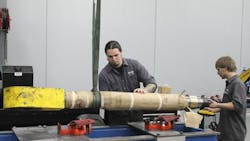 Workers make repairs using Price Engineering39s hydraulic cylinder repair bench Workers make repairs using Price Engineering39s hydraulic cylinder repair bench