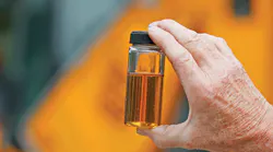 Closeup of a hand holding hydraulic fluid