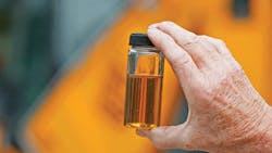 Closeup of a hand holding hydraulic fluid Closeup of a hand holding hydraulic fluid