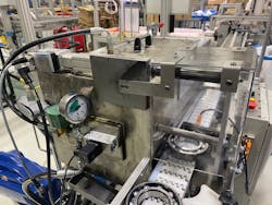 A roller bearing is about to be pulled into the TOG 110. The Festo EPCS 150-mm electric cylinder is mounted top of the machine. Cycle rate increased from 900 to 1,500 housing per hour with the addition of this electric cylinder.