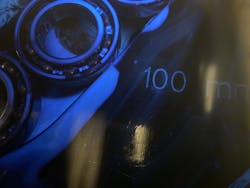 Housings inside the machine slide forward between guide rails, with each housing eventually reaching the center point directly under the preservative spray nozzle. Housings inside the machine slide forward between guide rails, with each housing eventually reaching the center point directly under the preservative spray nozzle.