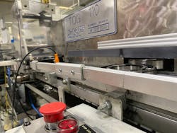 A sprayed roller bearing exits the TOG 110. Precision motion for the electric cylinder eliminates the possibility of units being pushed into the guide rail ,causing a jam and shutting down the line. A sprayed roller bearing exits the TOG 110. Precision motion for the electric cylinder eliminates the possibility of units being pushed into the guide rail ,causing a jam and shutting down the line.