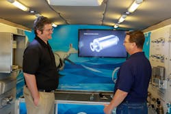 Vinny Calabrese, Process Automation Business Development, left, introduces Marcus Sweitzer, PennAir technical sales professional, to the range of Festo products in the company&rsquo;s truck-based mobile lab.