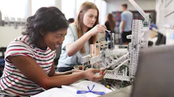 Students building a machine in an engineering class.