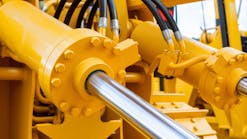 Hydraulic cylinders and hoses on heavy machinery