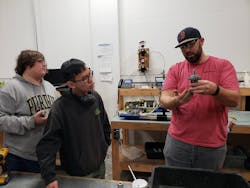 Burling Valve Production Manager Jeremy Carpenter (right) explains an internal part of a Burling regulator to Purdue Polytechnic Institute Team 15 members Hunter Kepner (left) and Ray Kurniawan (center) who are working on improving the superheated steam capabilities of this device.