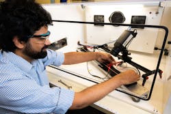 Aditya Nittala measures copper wire conductivity using specialized equipment developed at Pacific Northwest National Laboratory.