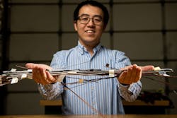 Xiao Li, a materials scientist, holds samples of highly conductive metal wires created on the patented Shear Assisted Processing and Extrusion platform.