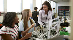woman teaching female students in engineering class woman teaching female students in engineering class
