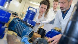 Engineers working with pumps and motors Engineers working with pumps and motors