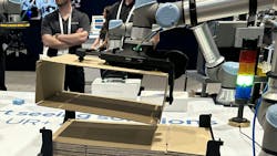 Impaqt Robotics box folding gripper on robot arm picks up flat boxes Impaqt Robotics box folding gripper on robot arm picks up flat boxes