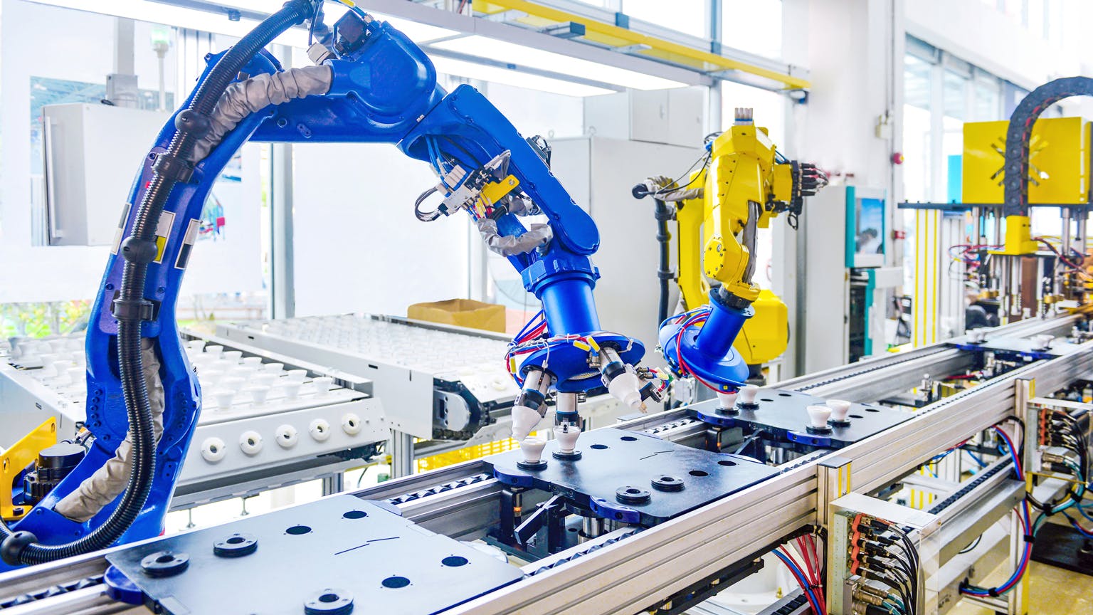 Robots assemble products along a manufacturing line