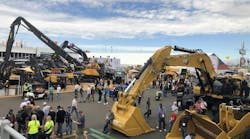 An overview of a CONEXPO outdoor lot featuring various types of construction machinery An overview of a CONEXPO outdoor lot featuring various types of construction machinery