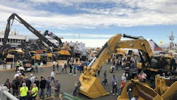 An overview of a CONEXPO outdoor lot featuring various types of construction machinery An overview of a CONEXPO outdoor lot featuring various types of construction machinery