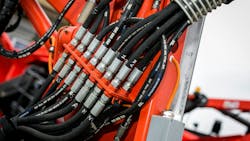 A close up view of hydraulic hoses and fittings on a machine A close up view of hydraulic hoses and fittings on a machine