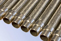 A closeup view of metal hydraulic hoses and fittings A closeup view of metal hydraulic hoses and fittings