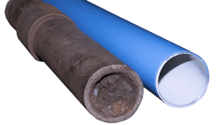 A clogged iron compressed air pipe next to an unclogged pipe A clogged iron compressed air pipe next to an unclogged pipe