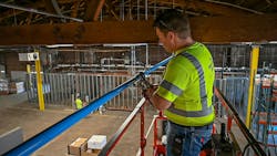 A person installing compressed air piping A person installing compressed air piping