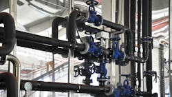 Compressed air piping in a facility is equipped with valves and gauges to aid airflow Compressed air piping in a facility is equipped with valves and gauges to aid airflow