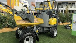 A compact electric construction machine on display at a tradeshow A compact electric construction machine on display at a tradeshow