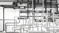 Pipes going in various directions to deliver compressed air to pneumatic systems Pipes going in various directions to deliver compressed air to pneumatic systems