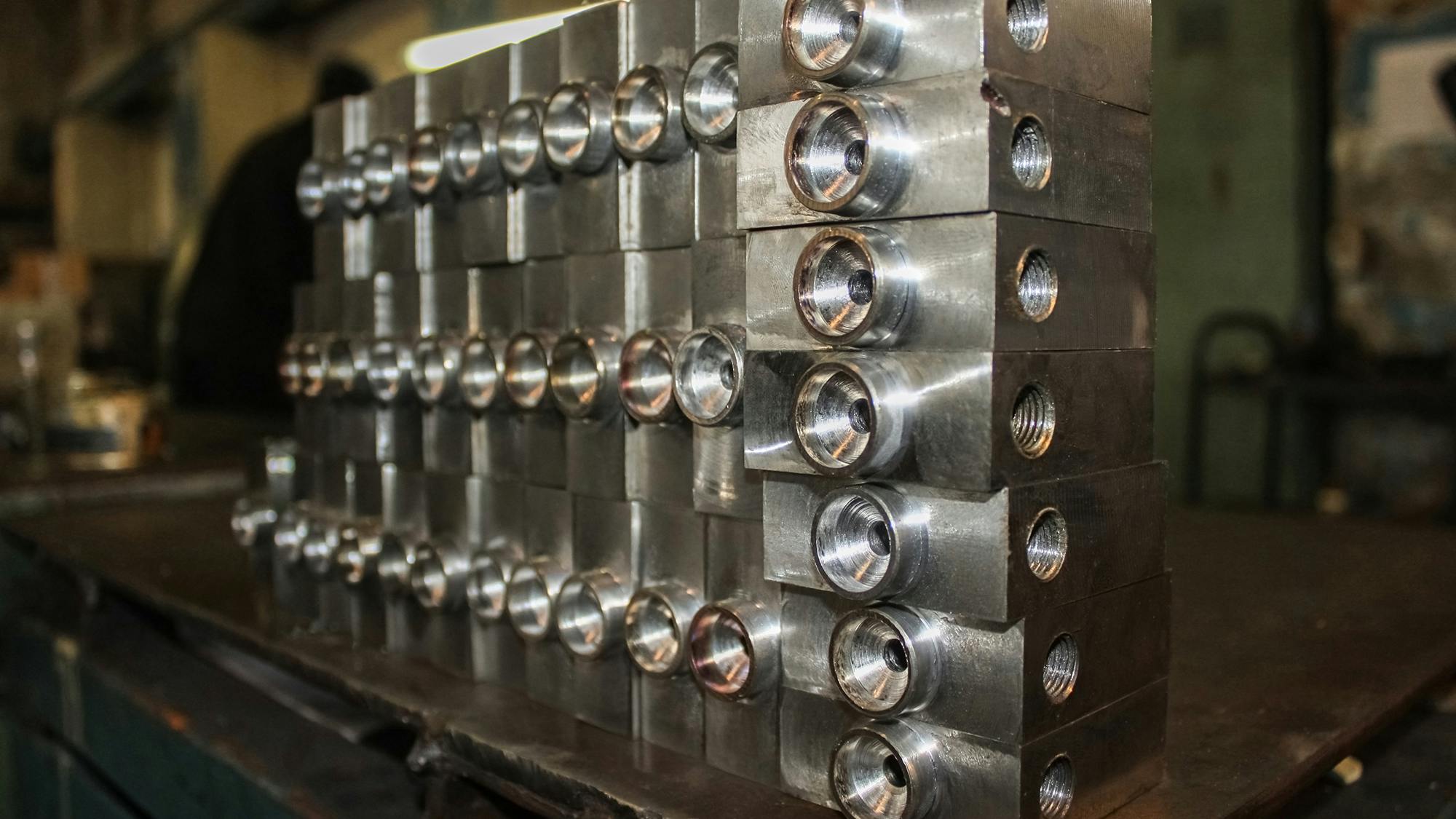 An image of stacked hydraulic valves in a manufacturing facility