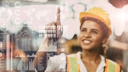 A young female engineer works on a superimposed digital screen A young female engineer works on a superimposed digital screen
