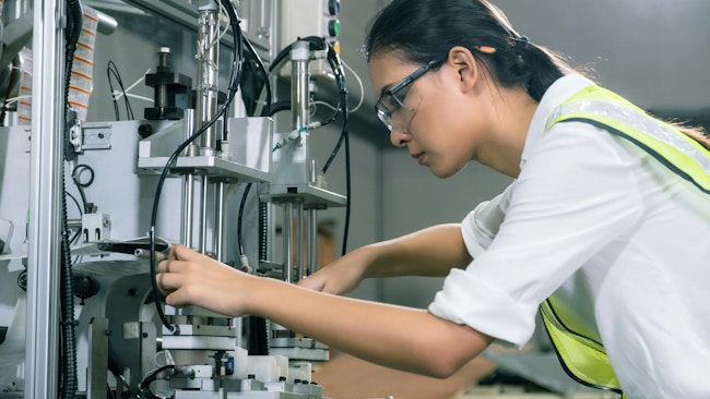 A female engineer working on a robot
