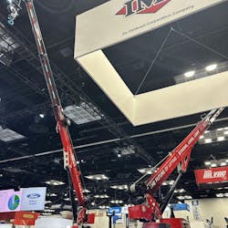 Two hydraulic cranes mounted on the back end of a work truck Two hydraulic cranes mounted on the back end of a work truck