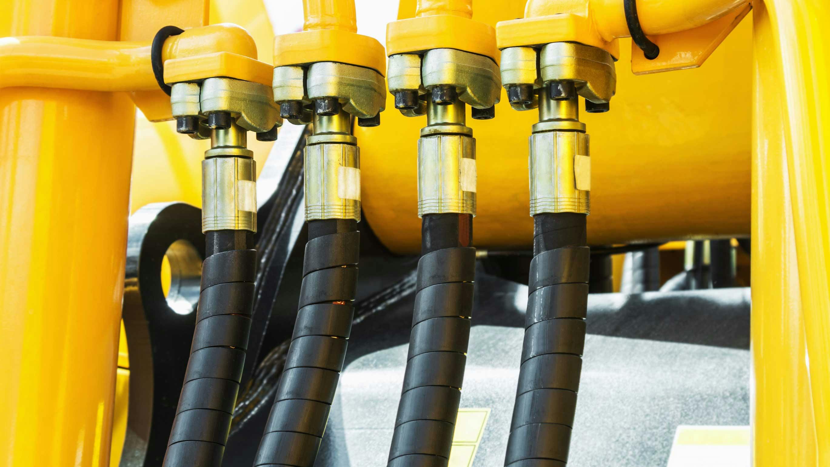 A close up view of hydraulic components on a piece of machinery