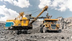 A mining excavator and haul truck working on a mine site A mining excavator and haul truck working on a mine site