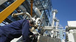 An image of an engineer performing maintenance on oil and gas equipment An image of an engineer performing maintenance on oil and gas equipment