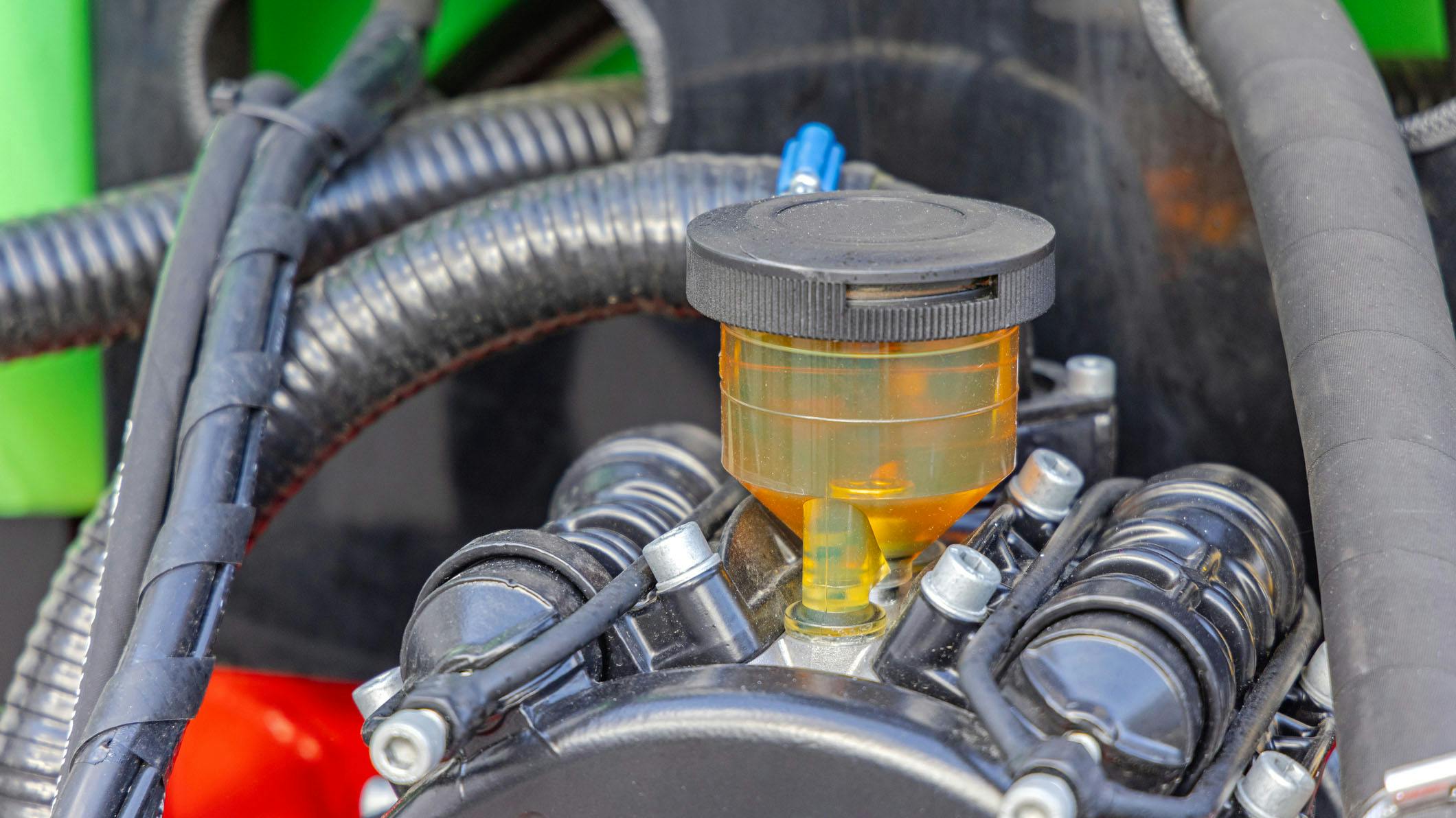 A close up image of a hydraulic fluid tank on a piece of mobile machinery