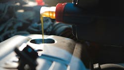 Oil being poured into a vehicle Oil being poured into a vehicle