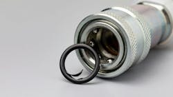 A close up view of a damaged hydraulic seal next to a coupler A close up view of a damaged hydraulic seal next to a coupler