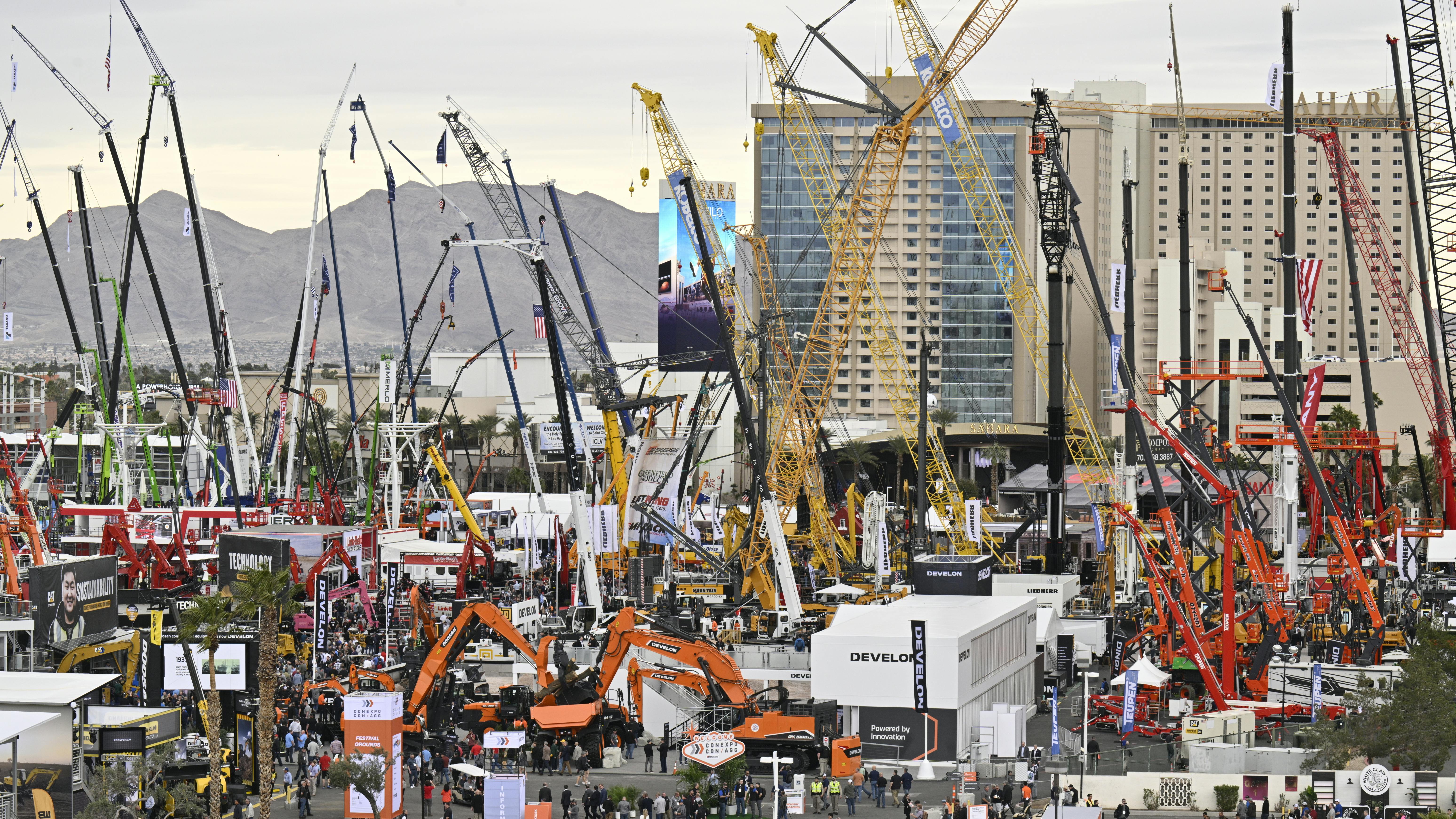 An aerial view of an outdoor exhibition lot at CONEXPO 2023 with various types of construction machines