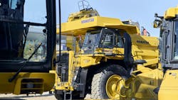 A large mine haul truck on display at a trade show A large mine haul truck on display at a trade show
