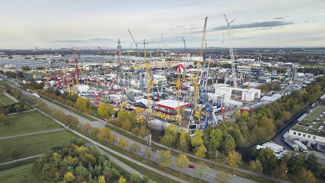 An aerial view of one of the outdoor exhibits at bauma filled with various types of construction and mining machinery