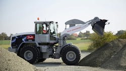 An electric wheel loader dumping dirt An electric wheel loader dumping dirt