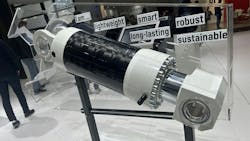 A hydraulic cylinder made of carbon fiber on display at a trade show A hydraulic cylinder made of carbon fiber on display at a trade show
