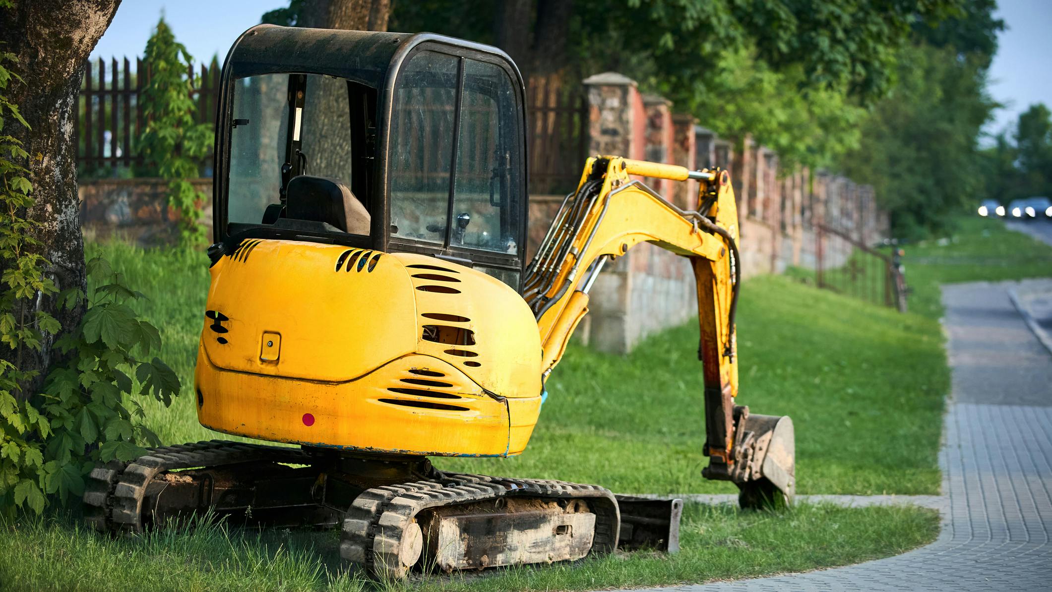 A mini excavator working in a residential area