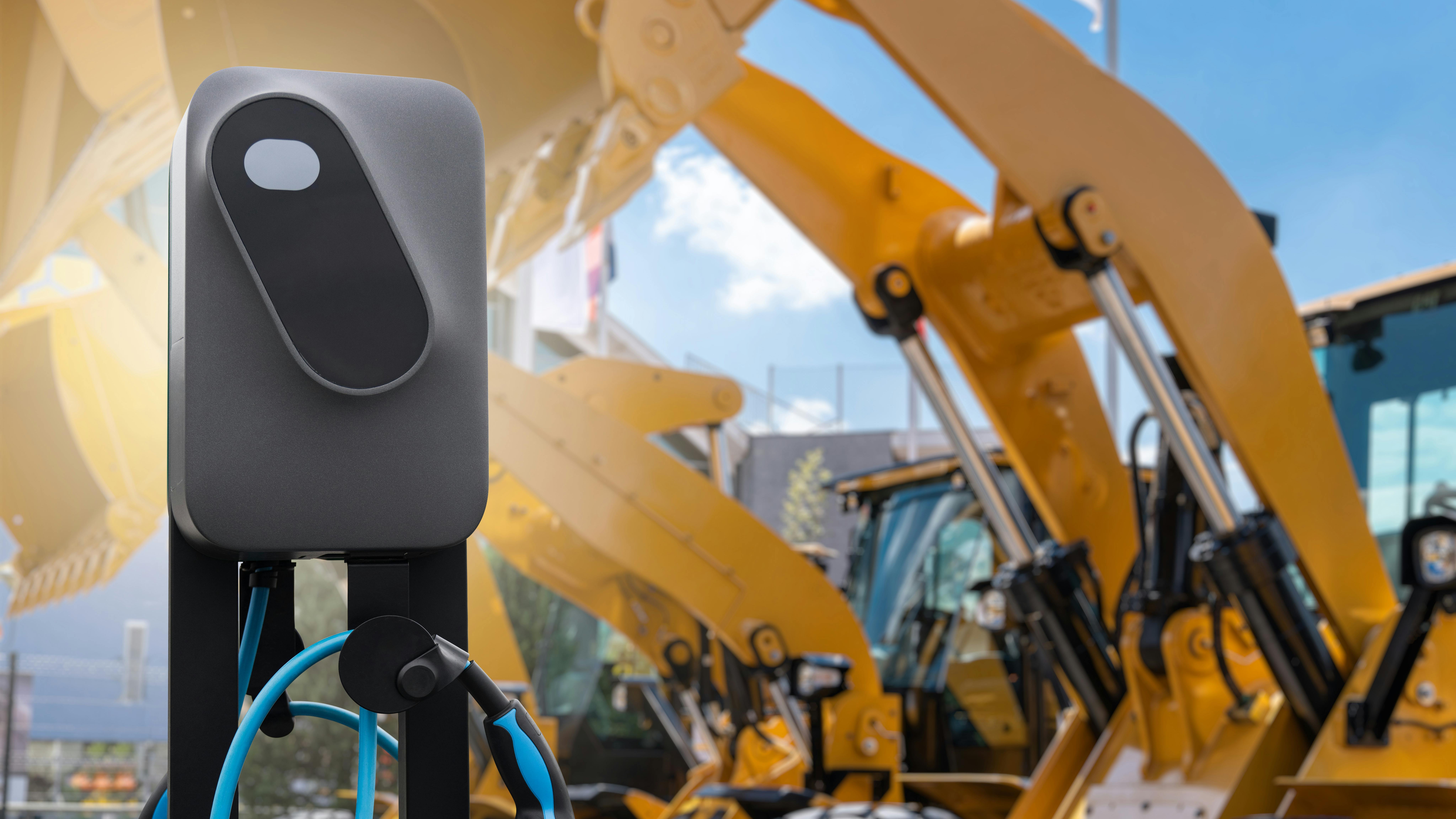 Electric construction machines with charging station
